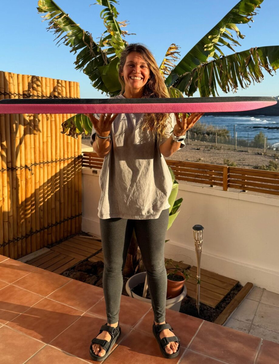 Isabela Sousa holding her Hexaboards bodyboard during a team rider presentation